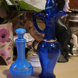 2 Vintage Avon bottles, decanters. Cobalt blue, light blue with gold trim.